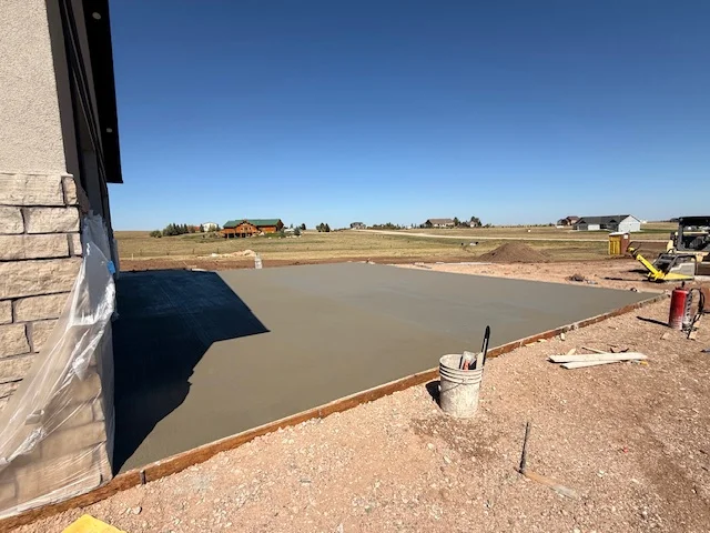 Concrete garage slab freshly poured for residential build in Cheyenne WY