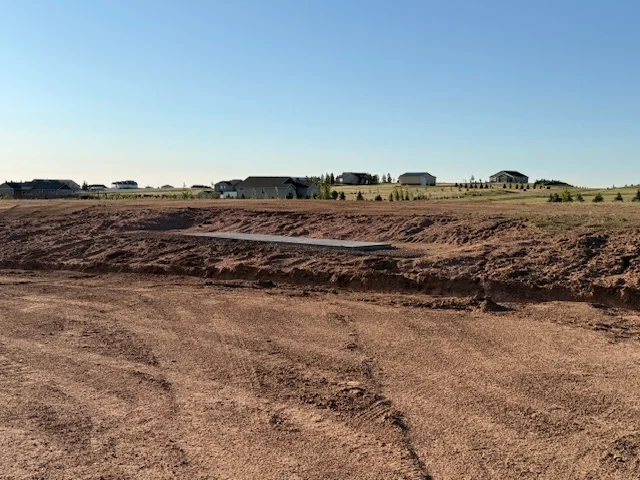 Graded building pad and driveway prep for new construction, southeast Wyoming
